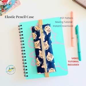 May include: A dark blue pencil case with a repeating leopard face pattern and a central gold zipper, attached to a light blue spiral notebook by an elastic band. Text includes Elastic Pencil Case, PDF Pattern, Sewing Tutorial, Instant Download, and Video Tutorial Included.