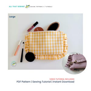 May include: A large rectangular zippered pouch featuring a yellow and white gingham pattern with ruffled side edges. The pouch is displayed with various cosmetic items including brushes, a compact, and a hairbrush. A circular inset shows a mauve version.