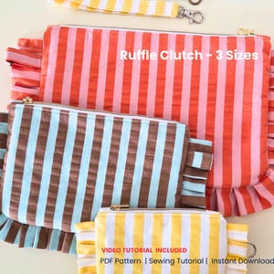 May include: Several striped ruffle clutches in different sizes. The largest is orange and pink, the medium one is brown and blue, and the smallest is yellow and white. The text "Ruffle Clutch - 3 Sizes" is displayed on the image.
