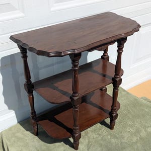 May include: A white ceramic mug with a black handle and the text "But First, Coffee" in a handwritten style. The mug is on a white surface. The mug is likely for hot beverages.