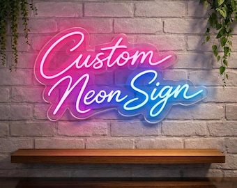 May include: A neon sign with the words "Custom Neon Sign" in a cursive font. The sign is lit with pink and blue neon lights and mounted on a brick wall. A wooden shelf is below the sign.