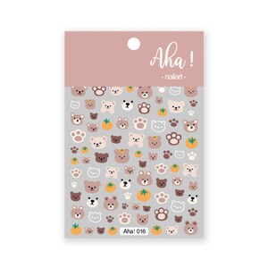 May include: Sheet of nail art stickers featuring a repeating pattern of cartoon bears, paw prints, and small orange fruits. The stickers are in shades of brown, tan, and white on a gray background. The text "Aha! nailart" is at the top.