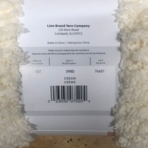 May include: Lion Brand Yarn Company label with the text "Make sure to match dye lot numbers." and the following information: Article # 937, Color # 098D CREAM CR&Egrave;ME, Lot # 76601. A barcode is also included.