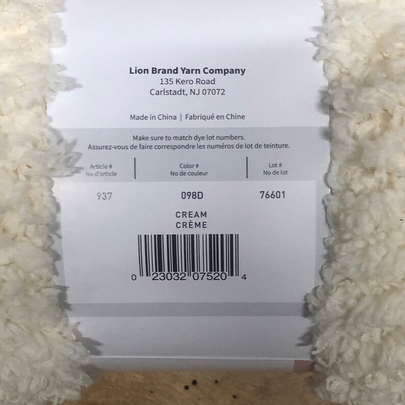 May include: Lion Brand Yarn Company label with the text "Make sure to match dye lot numbers." and the following information: Article # 937, Color # 098D CREAM CR&Egrave;ME, Lot # 76601. A barcode is also included.