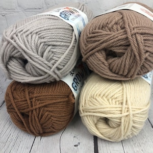 May include: Four balls of yarn in different shades of brown, beige, and grey. The yarn is labelled "GROW" and "100% Silk Wool".