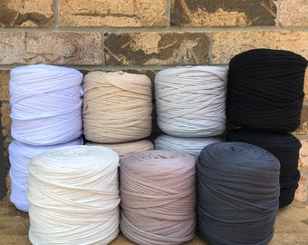 May include: Eight spools of yarn in various shades of beige, gray, and black. The yarn is made of a soft, stretchy material and is perfect for crocheting or knitting.