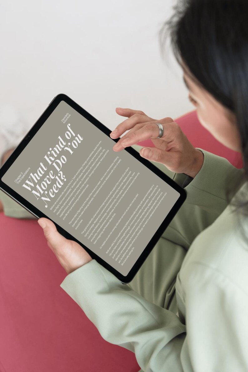 May include: A black tablet displaying a page with the title What Kind of Move Do You Need? and Chapter 2 The Expectations. The screen shows multiple paragraphs of text in a serif font against a light beige background, held by a person in a sage green shirt.