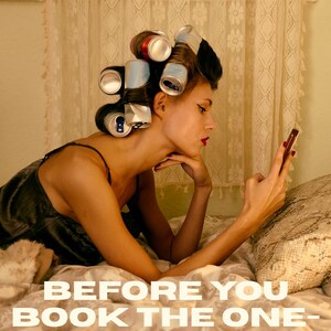 May include: A person with hair styled in aluminum soda cans as rollers, wearing a dark camisole, looking at a smartphone. The text reads: Disorderly Adventure. BEFORE YOU BOOK THE ONE-WAY FLIGHT, ASK BETTER QUESTIONS.