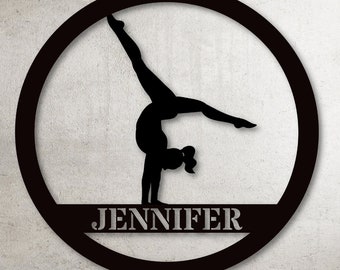 May include: Black silhouette of a gymnast performing a handstand on a beam, inside a black circle with the name "JENNIFER" on a white banner below the beam.