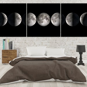 May include: A black and white triptych canvas wall art featuring a series of moon phases. The canvas is displayed above a brown duvet cover on a bed with white pillows.