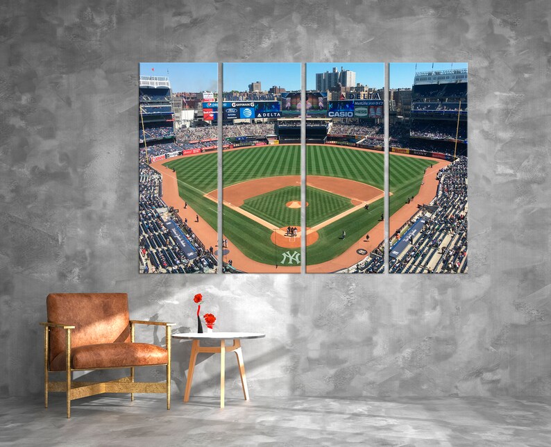 May include: A panoramic view of a baseball field from the stands, showing the green field, the dirt infield, and the stands filled with fans. The image is divided into three sections, with the text "CASIO" visible in the center section.