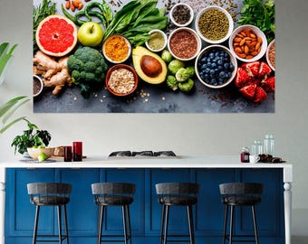 May include: A wall art print featuring a flat lay of fresh ingredients including a sliced grapefruit, green apple, broccoli, avocado, ginger root, spinach, blueberries, almonds, lentils, oats, and various spices arranged in small bowls on a dark surface.