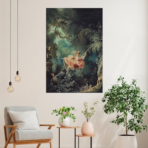 May include: A framed print of a Rococo painting showing a woman on a swing in a garden. The artwork uses pastel colours, with the woman in a pink dress. The background is filled with greenery and figures, creating a romantic scene.