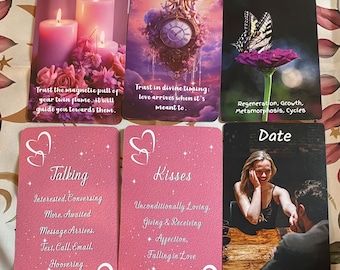 May include: A set of ten oracle cards with pink and white hearts, stars, and text. The cards feature phrases like "Twin Flame", "Divine Timing", "Change", "Talking", "Kisses", and "Date".