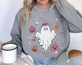 May include: A gray sweatshirt with a ghost wearing a witch hat and surrounded by pumpkins, skulls, and peace signs. The text "Boo!" is printed on the sweatshirt.
