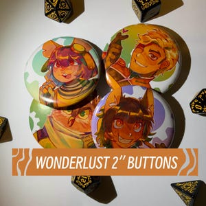 May include: A collection of round, colorful buttons featuring anime-style character illustrations. The buttons are approximately 2 inches in diameter and have a variety of designs, including a character with goggles and an owl. The text "WONDERLUST 2" BUTTONS" is displayed.