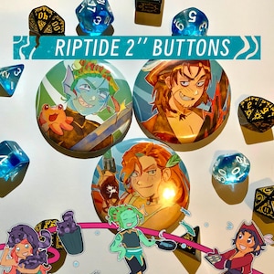 May include: Three round buttons, each 5 cm in diameter, featuring fantasy character illustrations. The buttons are labelled "Riptide 2" Buttons" in a teal banner. The image also includes various dice and character stickers.