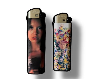 May include: Two lighters with different images. The first lighter has a picture of a woman with long dark hair. The second lighter has a picture of a woman with a floral crown.