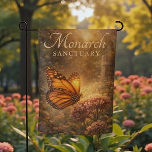 May include: A garden flag featuring a monarch butterfly with orange and black wings, perched on a cluster of pink flowers. The flag reads "Monarch Sanctuary" in elegant script, set against a backdrop of a sunlit garden.