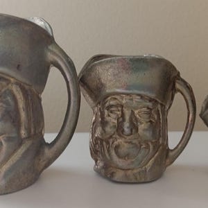 Set of three miniature Brass colour Toby Jugs