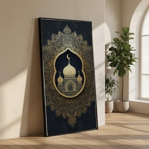 May include: A framed art print featuring a gold mosque design on a dark blue background. The mosque is framed by an arch and a crescent moon. The background has a detailed gold mandala pattern. The frame is black.