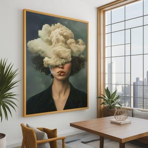 May include: A framed artwork shows a woman with a cloud covering her face, smoking a cigarette. She wears a black jacket with a subtle pattern. The artwork is displayed in a room with a wooden table and a large window overlooking a cityscape.