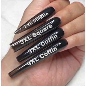 May include: Four black press-on nails of different lengths and shapes. The nails are labeled with their size and shape: 2XL Stiletto, 3XL Square, 3XL Coffin, and 4XL Coffin.