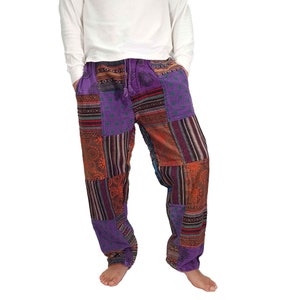 May include: Patchwork pants with a purple, orange, and brown color scheme. The pants have a drawstring waist and a relaxed fit.