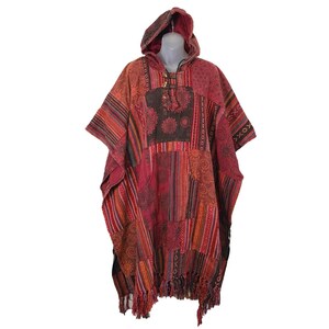 May include: A red, black, and orange patterned hooded poncho with fringe trim. The poncho is made of a soft, woven fabric and has a drawstring closure at the neck.