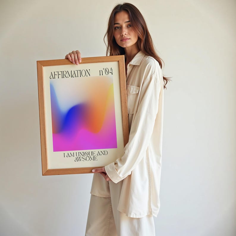a woman holding up a framed poster with the words affirmation on it