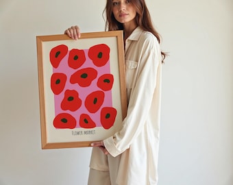 May include: A framed print with a pink background and red poppy flowers. The print has the text "FLOWER MARKET" at the bottom.