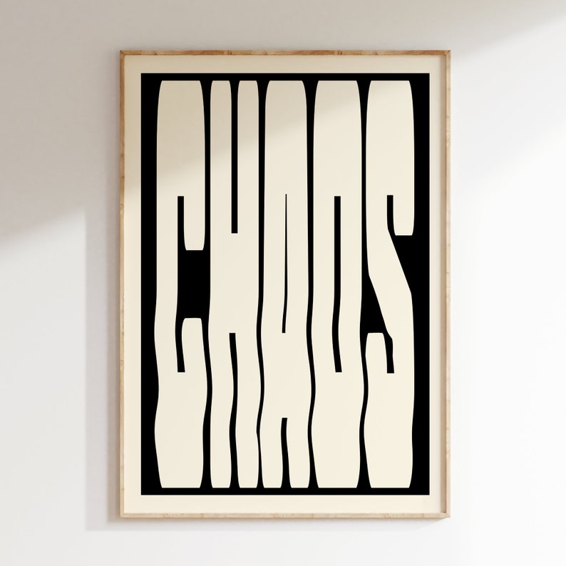 May include: A black and white framed print with the word "CHAOS" in a bold, stylized font. The letters are white and the background is black.