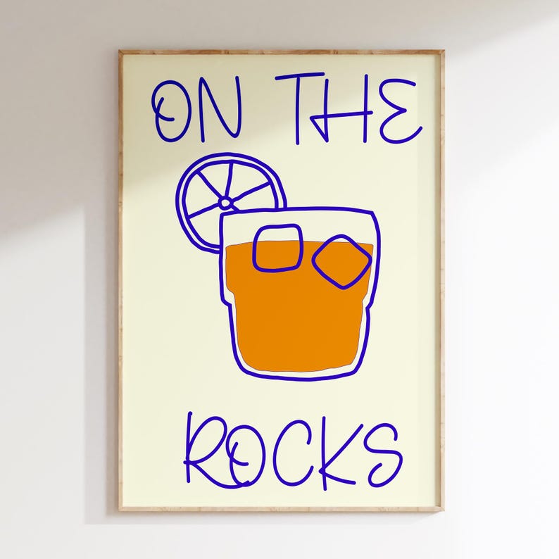 May include: A yellow background with blue text that reads "ON THE ROCKS". A cartoon drawing of a glass of orange juice with ice cubes and a lemon wedge is in the center of the image.