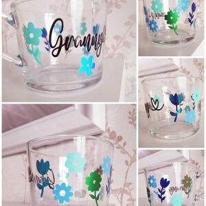 May include: A clear glass mug with a floral design and the word "Granny" in black lettering.