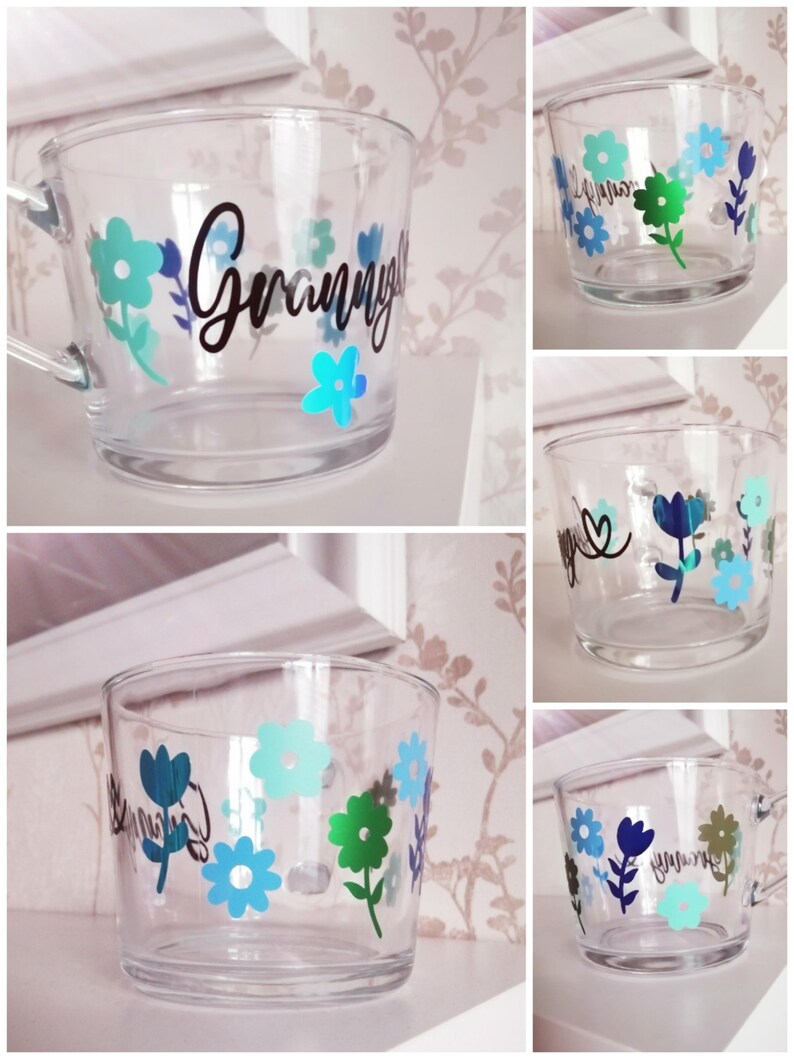 May include: A clear glass mug with a floral design and the word "Granny" in black lettering.