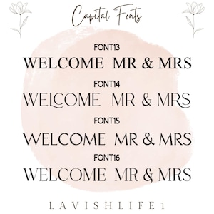 May include: A digital display showing four different font styles for the text WELCOME MR & MRS. Each font option is labeled FONT13 through FONT16. The background features a soft, pale pink watercolor-style shape and two line-art flower sketches.