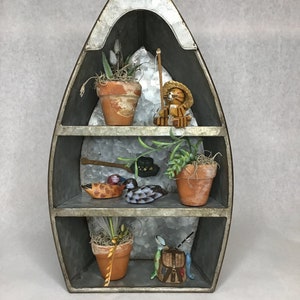 Canoe Accent with Faux Succlents and Vintage Fishing Collectables