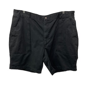 May include: Black shorts with two large front pockets and a button closure. The shorts have a classic design and are made of a durable fabric. They are suitable for casual wear and outdoor activities.