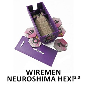 May include: A purple game box and accessories for the game "Wiremen Neuroshima Hex! 3.0". The box is open, revealing a stack of cards. Hexagonal game tiles with pink and gray designs are scattered around the box. The game's name is printed in black.