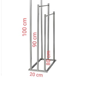 May include: A silver metal clothing rack with three bars. The rack is 45 cm wide, 100 cm tall, 90 cm deep, and 80 cm wide. The rack has a 20 cm wide base.