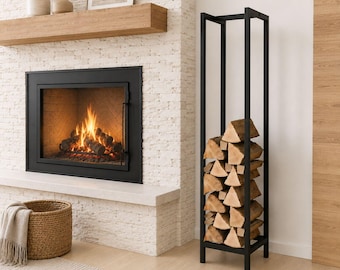 May include: A tall, rectangular black metal firewood rack with a vertical frame design. The rack is filled with stacked, light-colored split logs. The structure features four thin vertical posts connected by square horizontal supports at the top and base.