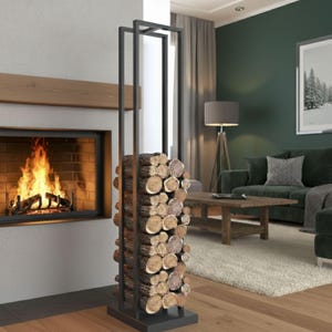 May include: A black metal log holder filled with stacked firewood. The holder has a rectangular frame design and is positioned in front of a fireplace with a burning fire. The room has a modern, cozy aesthetic.