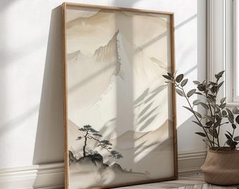 May include: A framed landscape art print featuring a mountain scene in neutral tones. The artwork depicts a mountain peak, smaller mountains, and a tree in the foreground. The frame is made of wood.