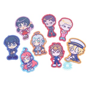 Photo of glittery stickers by marinewaltz. They are bright and colourful, and feature these synths: Hiyama Kiyoteru, Kaai Yuki, Miki, Utatane Piko, ZOLA PROJECT Kyo Yuu and Wil, Oliver
