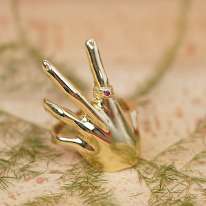 Ring shaped like a hand shop