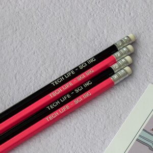 May include: Four black and pink pencils with the text "TECH LIFE - SCI INC" printed on them.