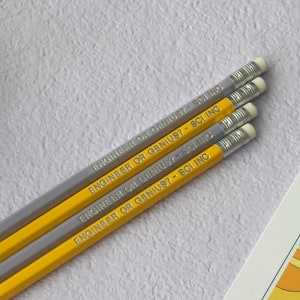 May include: Three yellow and grey pencils with the text "ENGINEER OR GENIUS? - SCI ING" printed on them.