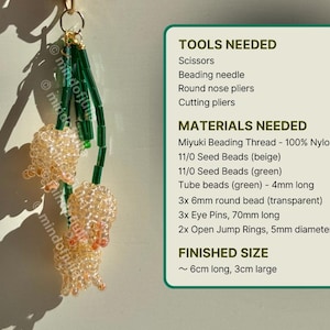 May include: A handmade beaded charm featuring two clusters of beige beads with green accents. The charm is suspended from a gold-colored ring. The image also includes a list of tools and materials needed to create the charm, and the finished size is approximately 6cm long and 3cm large.