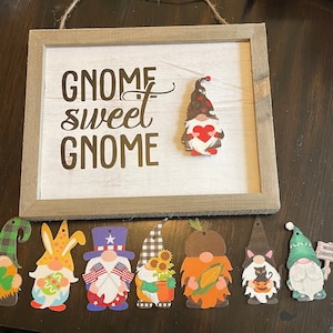 May include: A handmade wooden sign with the text "Welcome to our home" in a handwritten style. The sign is painted white with black lettering and a distressed finish, suitable for indoor or outdoor use.
