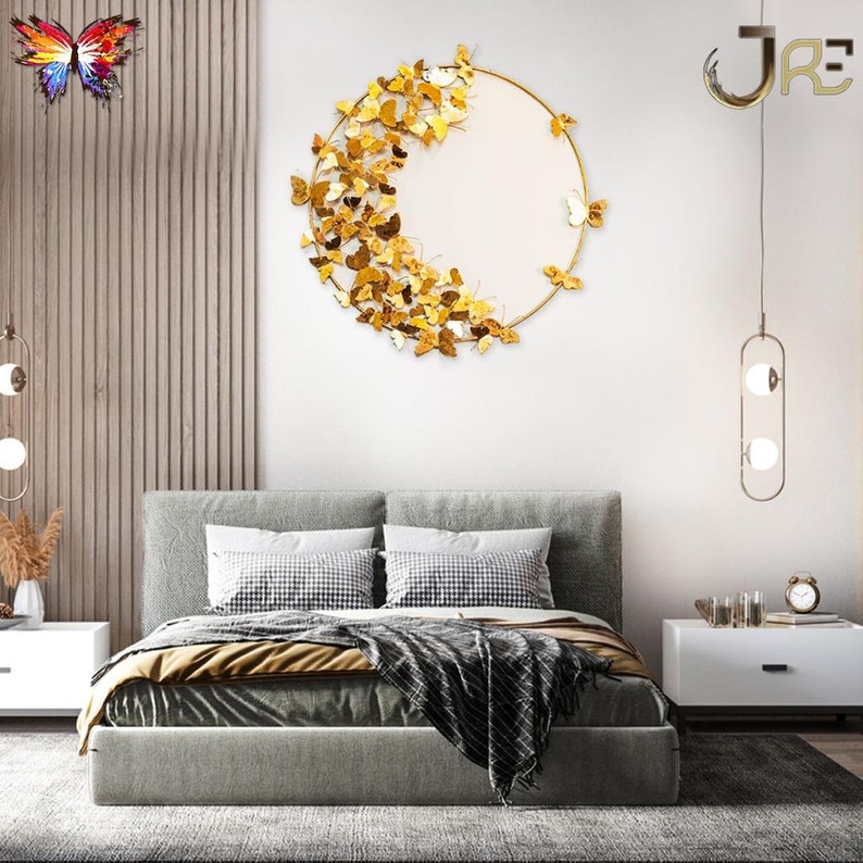 May include: A gold metal wall decor featuring a circular frame with a half-circle of butterflies. The butterflies are arranged in a cascading pattern, creating a dynamic and elegant design. The wall decor is perfect for adding a touch of nature and sophistication to any room.